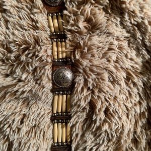 Faux bone belt with conchoes.